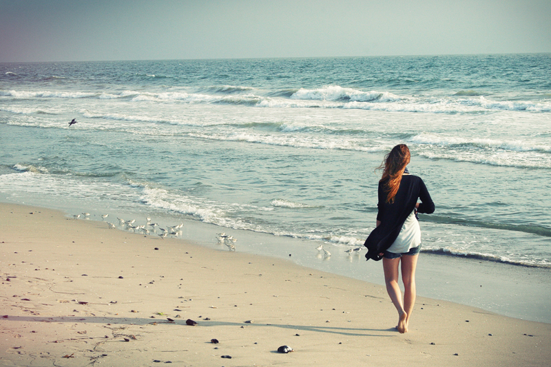 Woman walking on the beach in the morning