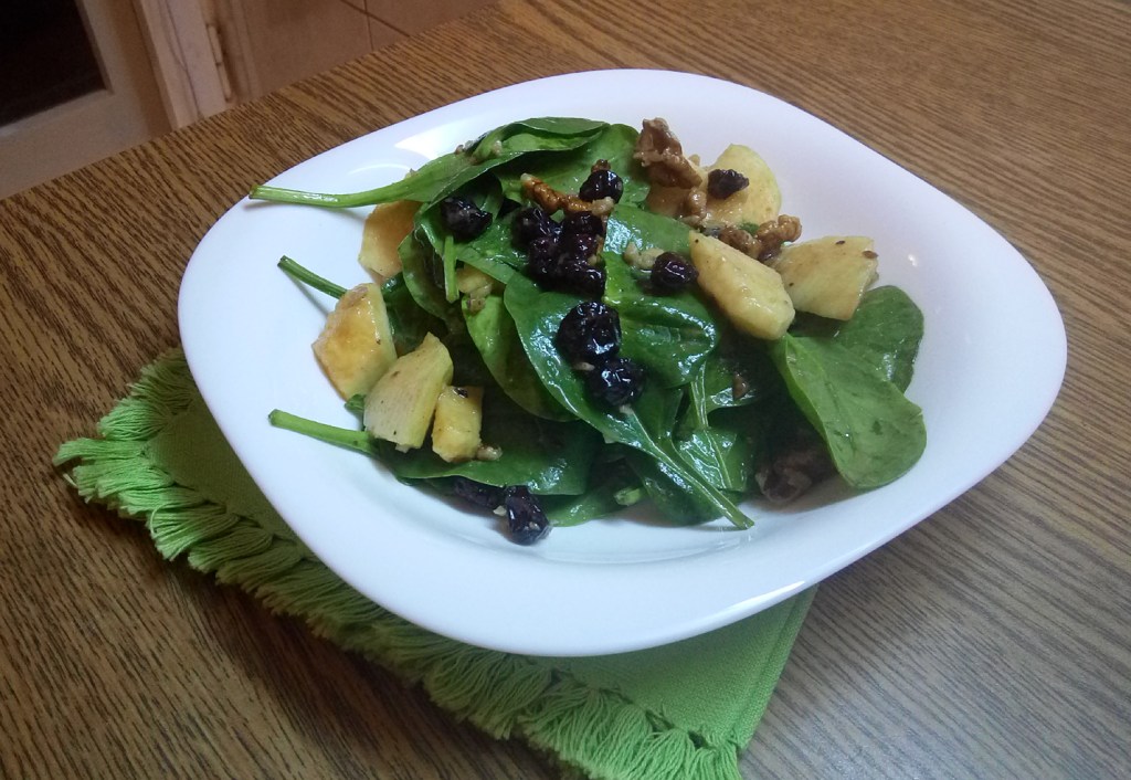 Sweet and savory baby spinach apple salad, with cranberries and walnuts