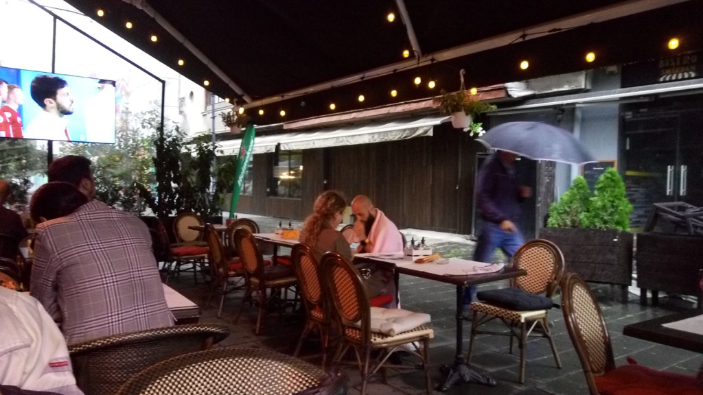 A customer wearing a blanket at Les Bourgeois restaurant in the Old Town, Bucharest,Romania