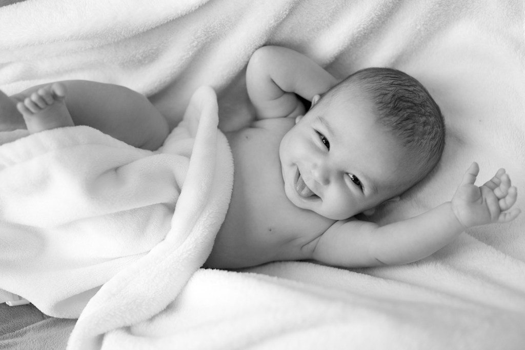 Newborn smiling, very cute
