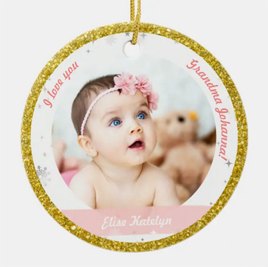 Elegant and festive new baby girl Christmas ornament for her Granny. With snowflakes, stars, and simulated gold glitter. Personalize with 2 photos, names, and year.