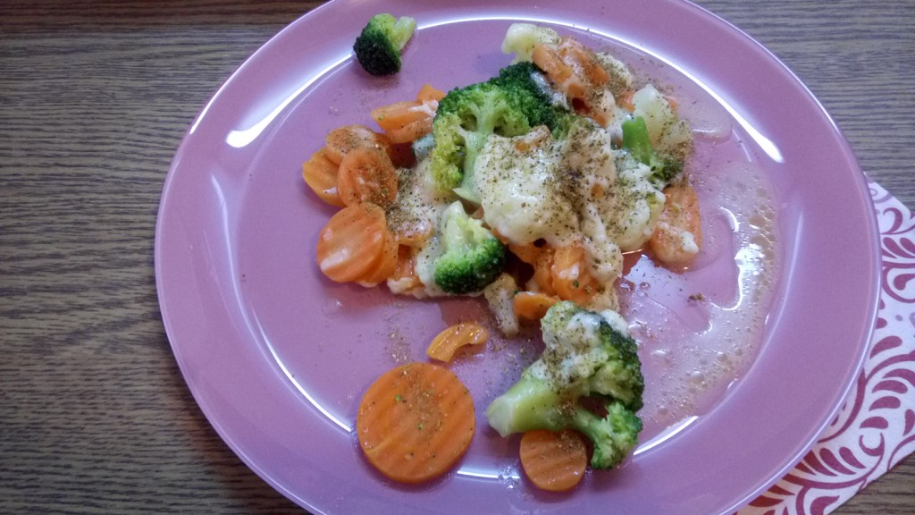 Veggie mix baked with shredded cheese, with spices, on a lavender plate