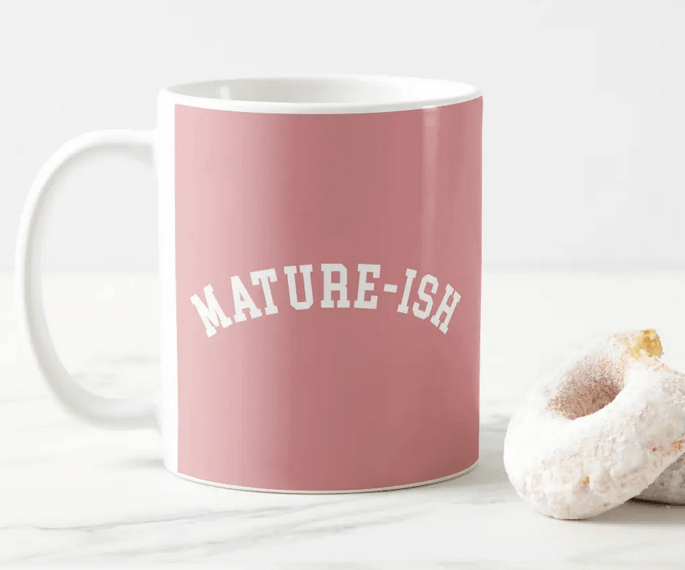 Funny coffee mug for a recent college graduate with the text MATURE-ISH a in block college font