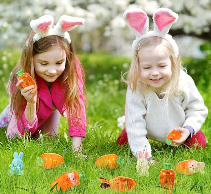 Cute orange and green carrot-shaped plastic containers with plush bunny rabbit toys inside, perfect for children's egg hunts