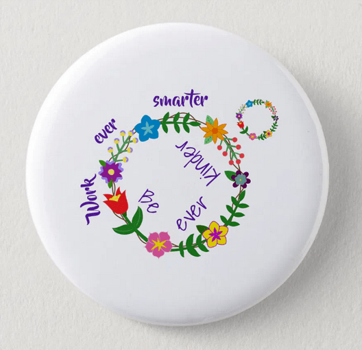 Work smarter and become kinder. A scatter kindness quote on a round button, with a wreath of colorful spring flowers, including wildflowers, that then is passed on emotionally and behavior-wise to another person