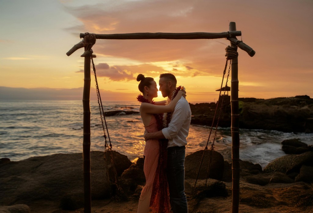 Couple embracing on the shore at sunset