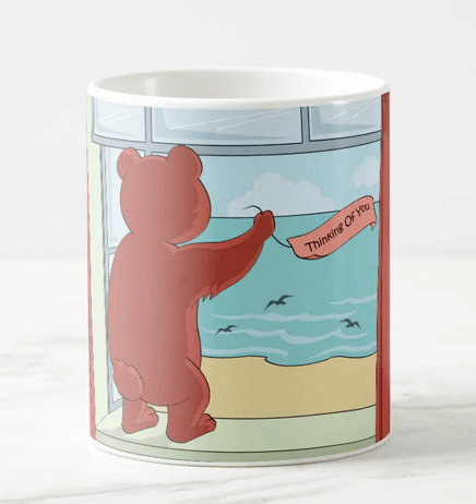Missing you mug for friends and long-distance partner. The illustration shows a cute teddy bear standing on a window ledge looking out to the ocean and holding a "Thinking of you" banner
