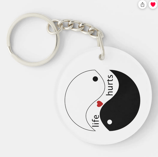 Keychain with the slogan "life hurts" with the yin-yang symbol and a heart
